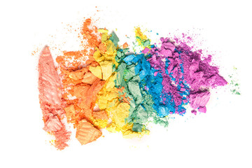 A broken rainbow colored eye shadow smear, make up palette isolated on a white background.