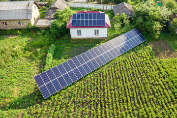 Aerial view of a house with blue solar panels for clean energy.