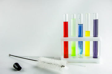 test tubes with multi-colored reagents on a white background. chemistry
