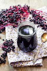 Homemade black elderberry syrup in glass jar