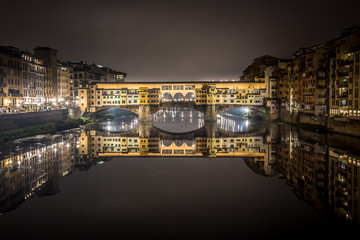 Night view of the Arno river and the famous Ponte Vecchio. Florence, Tuscany, Italy