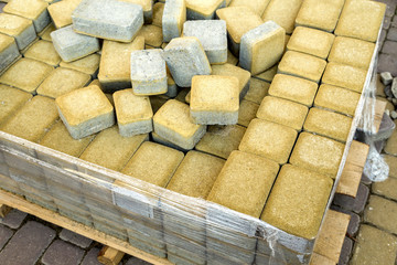 Installation of stone paving slabs in a yard.