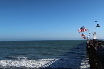 pier with flags and ocean view