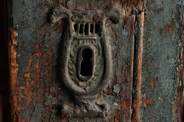 old iron keyhole with peeling paint