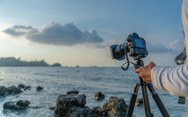 Camera With Tripod And Sea Scenery