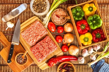 Raw minced meat. Preparation of stuffed peppers. Homemade food preparation. Vegetables and minced meat.