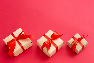 brown gift box with red ribbon on red background top view for christmas or celebrate