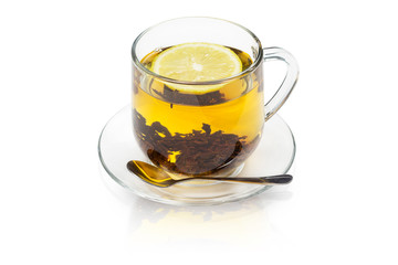 a cup of hot tea with tea leaves and lemon is isolated on a white background