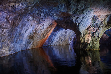 Underground Grotto Panorama.Types of a former underground marble quarry flooded with water. The...