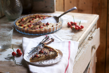 Pie stuffed with vegetables, cottage cheese and cream on a wooden background. Rustic style.