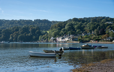 Fototapeta na wymiar Boats moored along the shore from Dittisham, Devon, United Kingdom