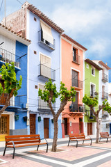 Fototapeta na wymiar Cityscape. Mediterranean street with bright colorful houses. Villajoyosa, Spain, Apr.2019