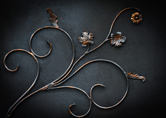  forged branch with leaves on black background