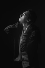 Portrait of young man in studio. Black and white. Profile