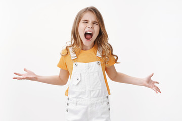 Angry little child, girl shouting out loud misbehave, arguing hate everyone standing pissed annoyed unfair treatment, whining showing bad temper, stand white background moody