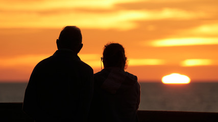 Silhouetted Old Couple Staring at the Sunset