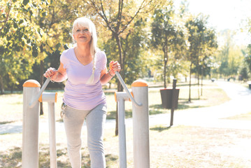 Senior woman exercising in park