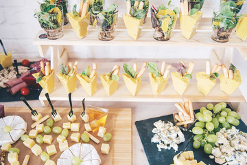 Catering service. Catering food. Table with food at event. Beautifully decorated catering banquet table with different food snacks and appetizers with sandwich.