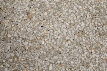 Texture béton désactivé en gros plan avec graviers blanc clair et gris foncé et couleur