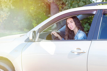 Young woman driving her car. Attractive young girl driver in new car