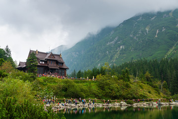 Wooden cabin next to the sea eye in the Tatras - obrazy, fototapety, plakaty