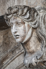 Fototapeta na wymiar Facade ancient sculpture of beautiful Venetian woman as decoration of Doge Palace in Venice, Italy