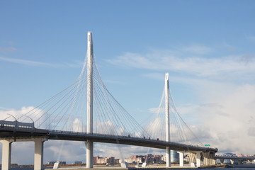 Cable-stayed bridge over a large river on a sunny day