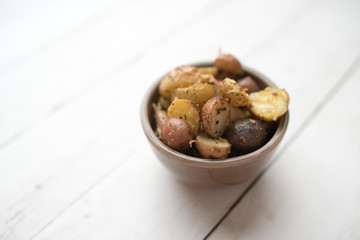 Delicious Roasted mini potato with spices and Parmesan cheese, cut in halves
