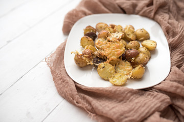 Delicious Roasted mini potato with spices and Parmesan cheese, cut in halves