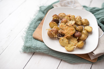 Delicious Roasted mini potato with spices and Parmesan cheese, cut in halves