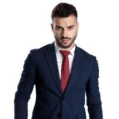 Tough young businessman wearing a blue navy suit