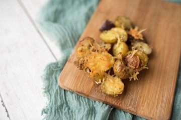 Delicious Roasted mini potato with spices and Parmesan cheese, cut in halves