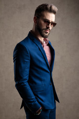 Fototapeta premium businessman standing with hands in pockets looking at camera confident