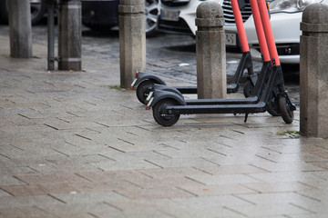 Electric scooters are on the road in the rain