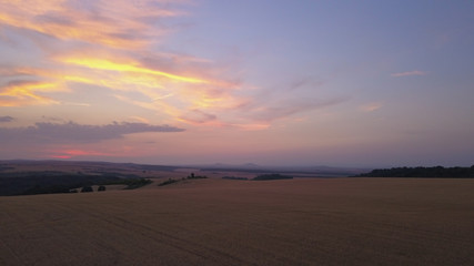 Fototapeta na wymiar Aerial view of a Agricultural fields at sunset or sunrise in Europe. Drone shot