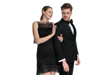 Unimpressed boyfriend looking over his shoulder at his lover