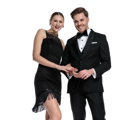 Happy couple smiling and holding each other’s arm