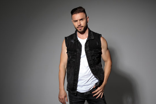 Determined casual man posing and wearing a black jeans vest