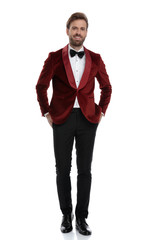 happy young fashion model smiling and wearing red velvet tuxedo