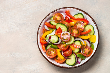 Vegetable salad on light table top view.