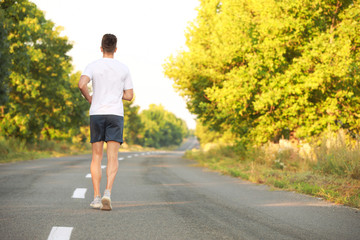 Sporty young man running outdoors