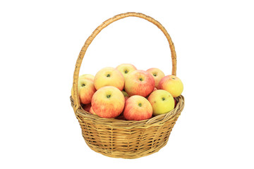 Wicker basket with apples of the new harvest isolated on white background
