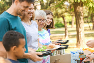 Poor people receiving food from volunteers