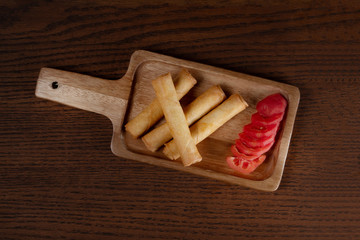 Top view of spring rolls isolated on wooden background
