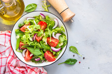 Green salad from fresh leaves and tomatoes.