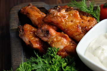 Hot appetizer on a wooden black plate on a dark wooden background. Restaurant menu