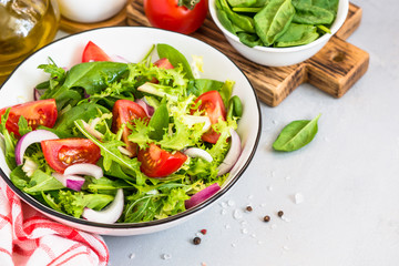 Green salad from fresh leaves and tomatoes.