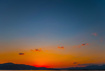 Fototapeta premium Natural Sunrise Sundown Over Sea Horizon island silhouette