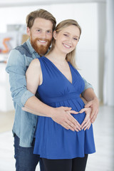 Fototapeta premium man hugs his wife in turban in checkered shirts