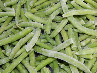 Closeup of frozen green beans with ice crystals, kitchen-ready for cooking
